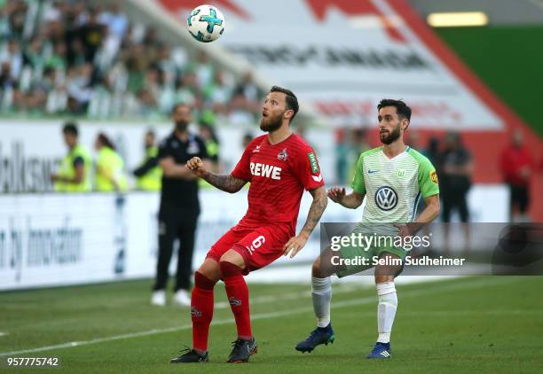 Marco Hoeger of Koeln fights for the ball with Yunus Malli of Wolfsburgduring the Bundesliga match between VfL Wolfsburg and 1. FC Koeln at...