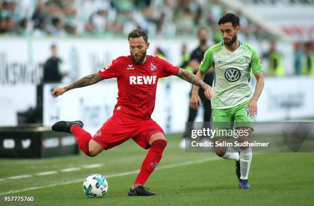 Marco Hoeger of Koeln fights for the ball with Yunus Malli of Wolfsburgduring the Bundesliga match between VfL Wolfsburg and 1. FC Koeln at...