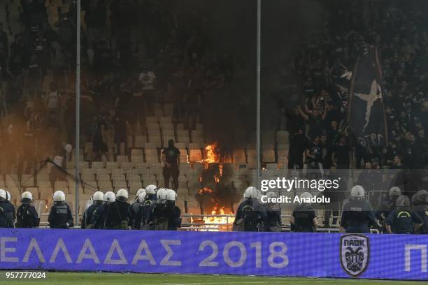 Fans clash with police officers after the Greek cup final match between AEK Athens F.C. And PAOK FC at Athens Olympic Sports Complex in Athens,...