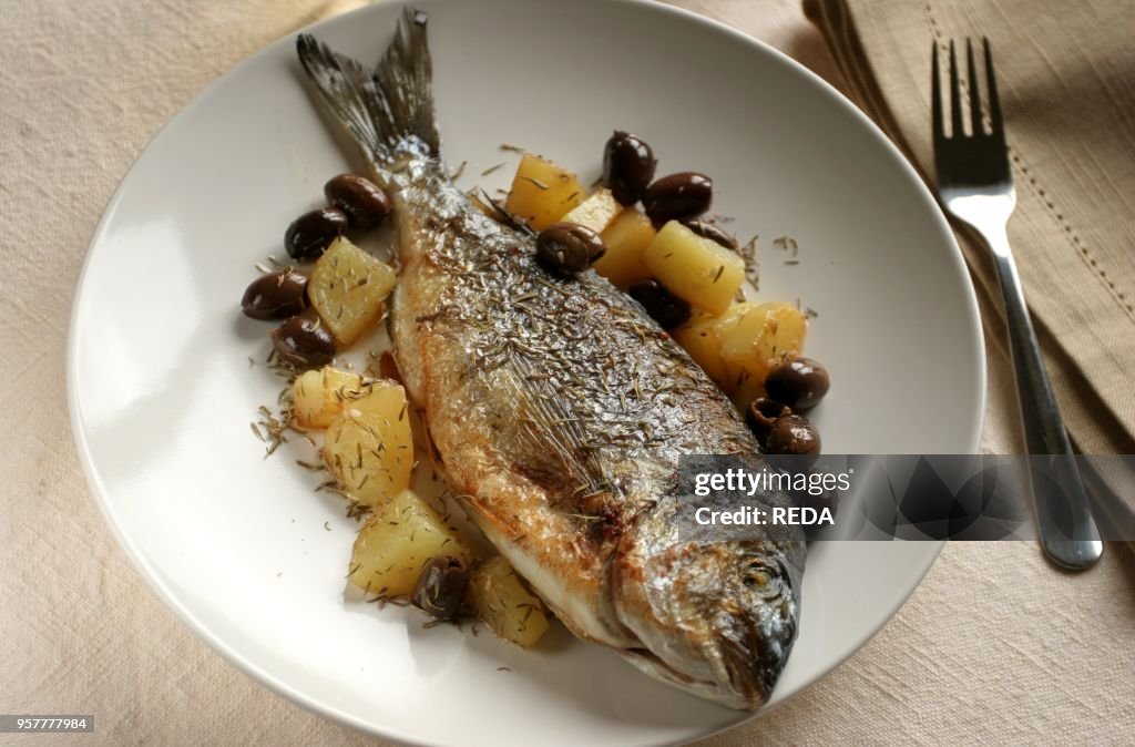 Gilthead Bream with Potatoes and Olives. Italy