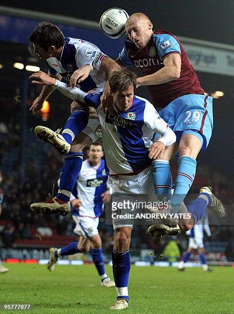 Aston Villa's English defender James Collins vies with Blackburn Rovers' Norweigan midfielder Morten Gamst Pedersen and Blackburn Rovers' New Zealand...