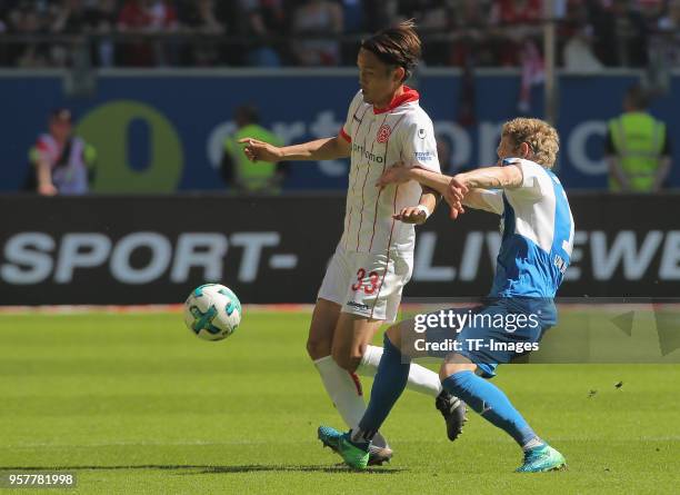 Takashi Usami of Duesseldorf and Johannes van den Bergh of Kiel battle for the ball during the Second Bundesliga match between Fortuna Duesseldorf...