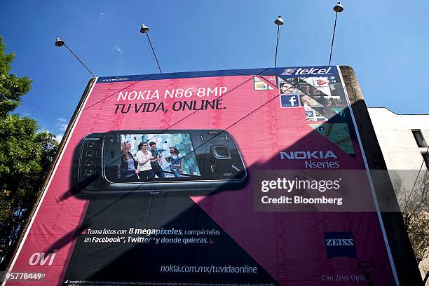 Billboard for a Nokia Oyj N86 mobile phone offered through Telcel, America Movil SAB's Mexican wireless unit, sits on display in Mexico City, Mexico,...