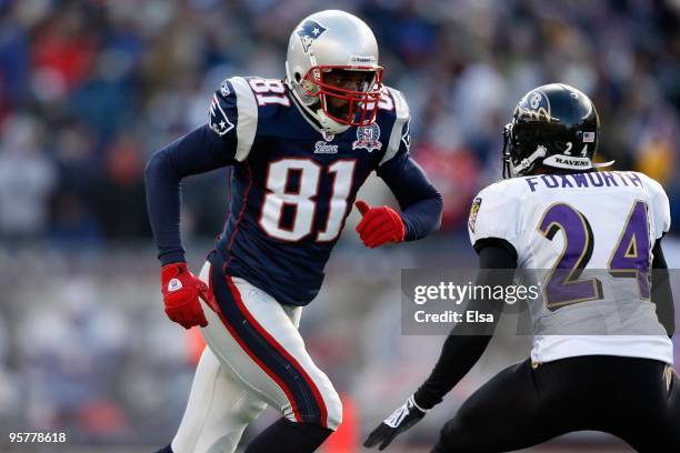 Randy Moss of the New England Patriots runs a route against Dominique Foxworth of the Baltimore Ravens during the 2010 AFC wild-card playoff game at...