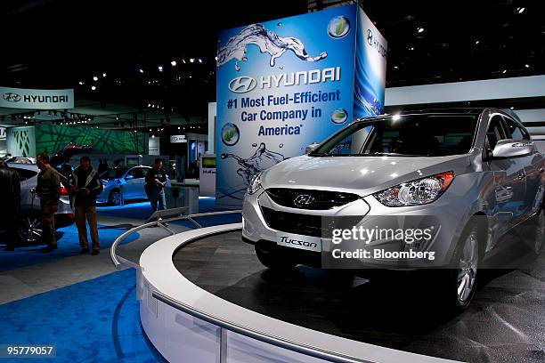 Hyundai Motor Corp.'s Tucson sport utility vehicle sits on display in front of a sign reading "Hyundai: #1 Most Fuel-Efficient Car Company In...