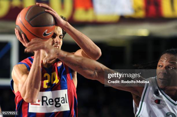 Victor Sada, #24 of Regal FC Barcelona competes with David Hawkins, #34 of Montepaschi Siena during the Euroleague Basketball Regular Season...