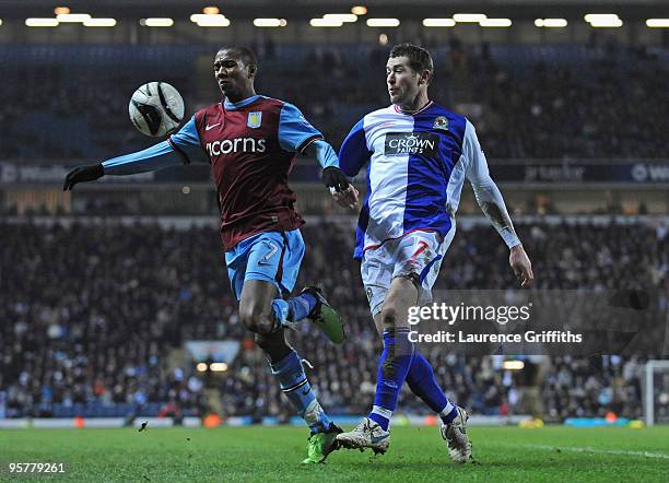 Ashley Young of Aston Villa controls the ball under pressure from Brett Emerton of Blackburn Rovers during the Carling Cup Semi Final match between...