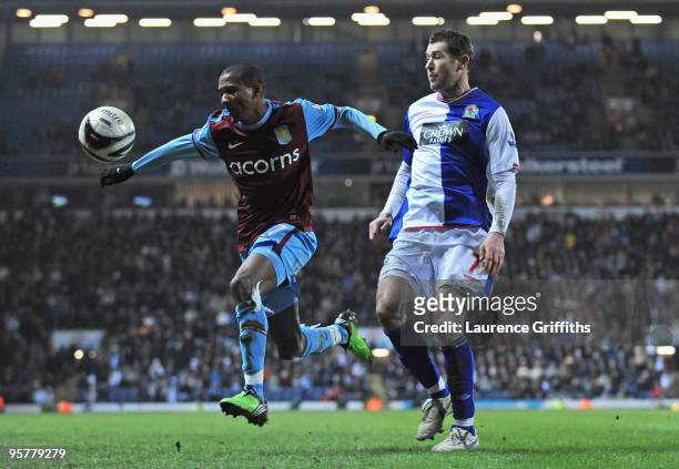 Ashley Young of Aston Villa controls the ball under pressure from Brett Emerton of Blackburn Rovers during the Carling Cup Semi Final match between...