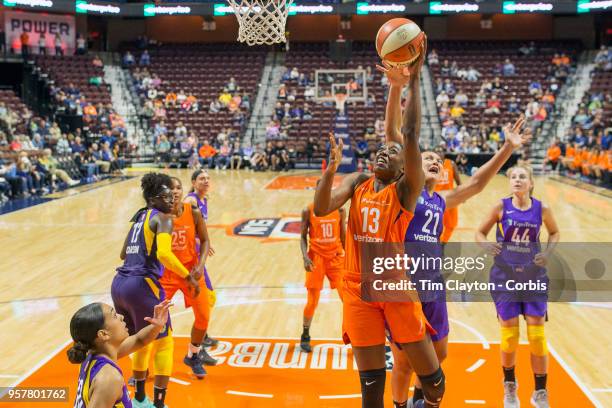 May 7: Chiney Ogwumike of the Connecticut Sun drives to the basket defended by Mistie Bass of the Los Angeles Sparks during the Connecticut Sun Vs...