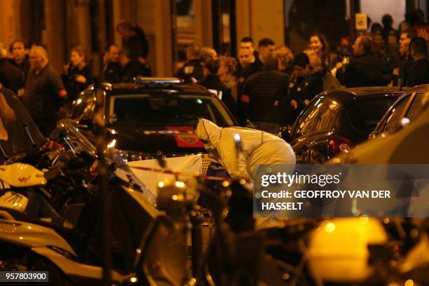 Forensic officer inspects the area in Monsigny street in Paris centre after one person was killed and several injured by a man armed with a knife,...