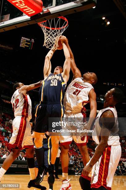 Tyler Hansbrough of the Indiana Pacers looks to score against James Jones and Jamaal Magloire of the Miami Heat during the game on December 27, 2009...