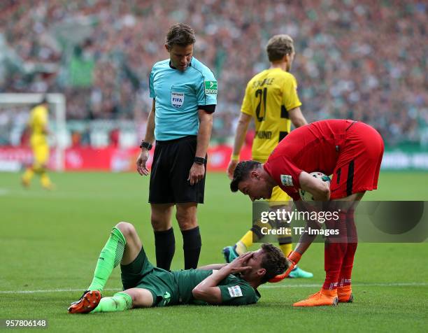 Referee Dr. Felix Brych looks on Sebastian Langkamp of Bremen and Goalkeeper Jiri Pavlenka of Bremen during the Bundesliga match between SV Werder...