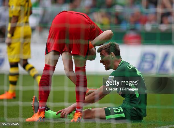 Goalkeeper Jiri Pavlenka of Bremen speaks with Sebastian Langkamp of Bremen during the Bundesliga match between SV Werder Bremen and Borussia...