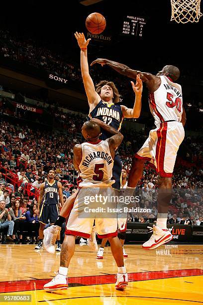 Josh McRoberts of the Indiana Pacers shoots against Quentin Richardson and Joel Anthony of the Miami Heat during the game on December 27, 2009 at...