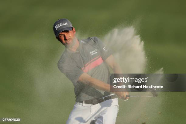 Webb Simpson of the United States plays a shot from a bunker on the 18th hole during the third round of THE PLAYERS Championship on the Stadium...