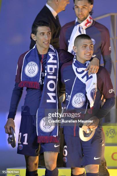 Angel Di Maria and Marco Verratti of Paris Saint-Germain react after receiving the Champions Trophy after the Ligue 1 match between Paris Saint...