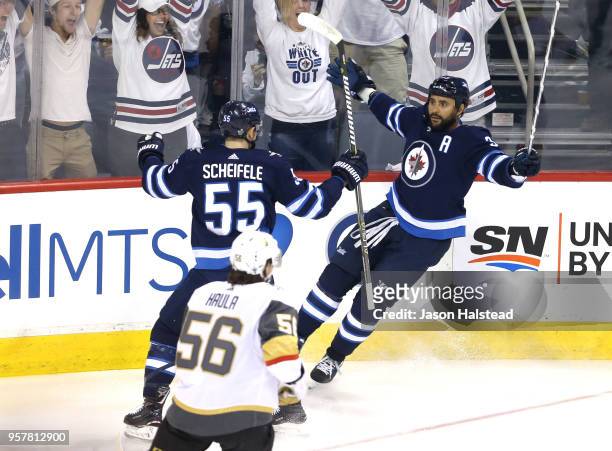 Dustin Byfuglien of the Winnipeg Jets is congratulated by his teammate Mark Scheifele after scoring a first period goal against the Vegas Golden...