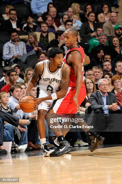 Roger Mason Jr. #8 of the San Antonio Spurs looks to pass around Dante Cunningham of the Portland Trail Blazers during the game on December 23, 2009...