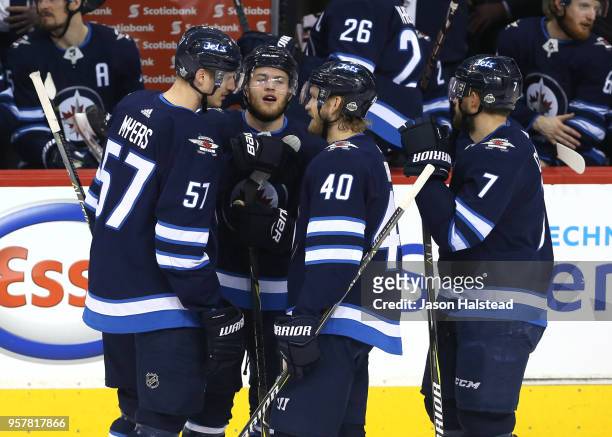 Joel Armia of the Winnipeg Jets is congratulated by his teammates after scoring a first period goal against the Vegas Golden Knights in Game One of...