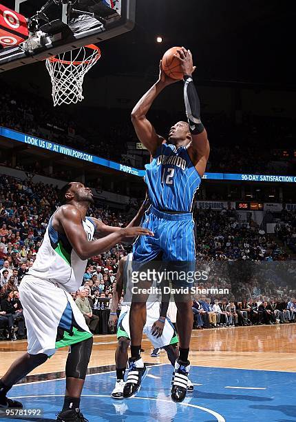 Dwight Howard of the Orlando Magic goes up for a shot against Al Jefferson of the Minnesota Timberwolves during the game at Target Center on January...