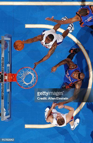 Ben Gordon of the Detroit Pistons shoots a layup against Jonathan Bender and Al Harrington of the New York Knicks during the game at the Palace of...