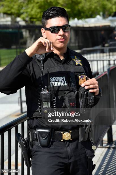 United States Secret Service officer stands guard along Pennsylvania Avenue in front of the White House in Washington, D.C.