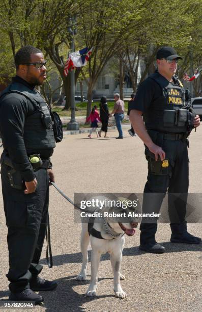 United States Secret Service officers and their canine partner patrol Pennsylvania Avenue in front of the White House in Washington, D.C.