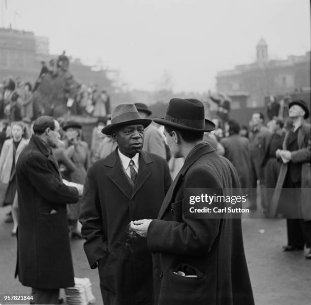 Two men talking in Trafalgar Square, where crowds have gathered for the wedding of Princess Elizabeth and Philip Mountbatten, Duke of Edinburgh, at...