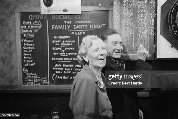 Patrons scoring a game of darts at the Crown public house, on Blackfriars Road, London, during celebrations of the wedding of Princess Elizabeth and...