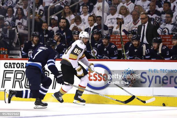 Alex Tuch of the Vegas Golden Knights is defended by Ben Chiarot of the Winnipeg Jets during the first period in Game One of the Western Conference...