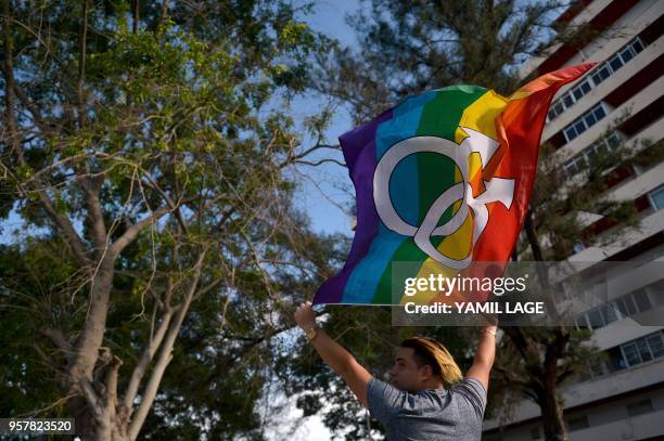 Cuban waves the rainbow flag at the gay pride parade during the celebration of the day against homophobia and transphobia in Havana, on May 12, 2018.