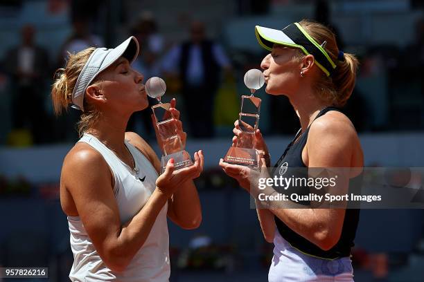 Elena Vesnina of Russia and Ekaterina Makarova of Russia kiss their trophies after winning Timea Babos of Hungry and Kristina Mladenovic of France in...