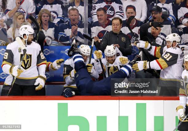 Blake Wheeler of the Winnipeg Jets is checked into the Vegas Golden Knights bench during the first period in Game One of the Western Conference...