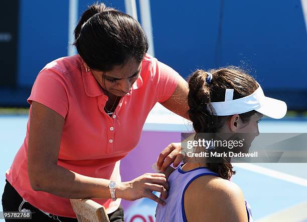 Laura Robson of Great Britain receives treatment from a trainer in her Women's Qualifying second round match against Michaella Krajicek of the...