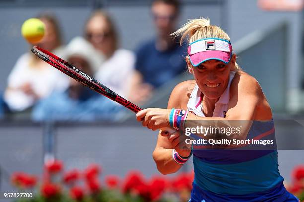 Timea Babos of Hungry in action during the match between Ekaterina Makarova and Elena Vesnina of Russia during day eight of the Mutua Madrid Open at...