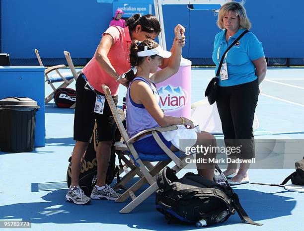 Laura Robson of Great Britain receives treatment from a trainer in her Women's Qualifying second round match against Michaella Krajicek of the...