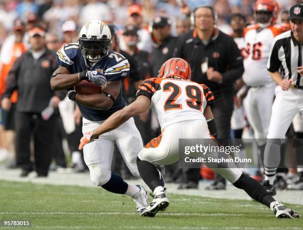 Running back LaDainian Tomlinson#21 of the San Diego Chargers carries the ball against defensive back Leon Hall of the Cincinnati Bengals on December...