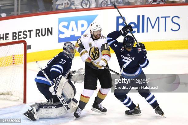 Connor Hellebuyck tends to net as teammate Ben Chiarot and James Neal of the Vegas Golden Knights battle for position during the second period in...