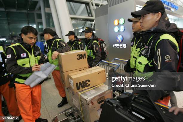 South Korean rescue team including doctors and nurses prepare to leave for quake-ridden Haiti at the Incheon International Airport on January 15,...