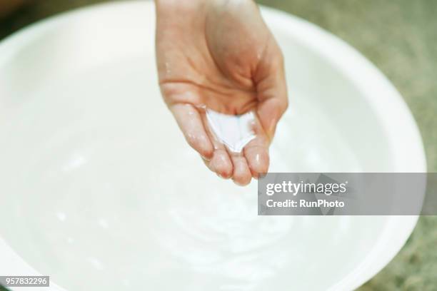 woman's hand in bowl of water - testing the water stock pictures, royalty-free photos & images