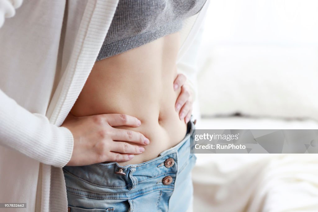 Close-Up Of Woman Touching Stomach