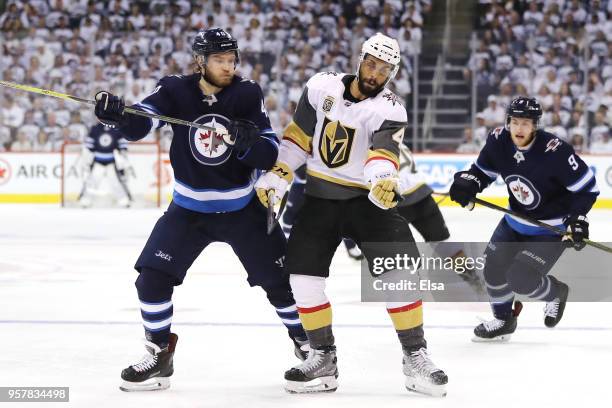 Pierre-Edouard Bellemare of the Vegas Golden Knights grabs the puck against Joel Armia of the Winnipeg Jets during the second period in Game One of...