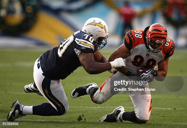 Tight end J.P. Foschi of the Cincinnati Bengals is tackled by defensive end Alfonso Boone of the San Diego Chargers on December 20, 2009 at Qualcomm...