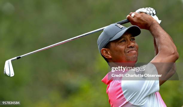 In a May 5 file image, Tiger Woods watches the flight of his ball from the 6th tee at Quail Hollow Club in Charlotte, N.C., during third-round action...