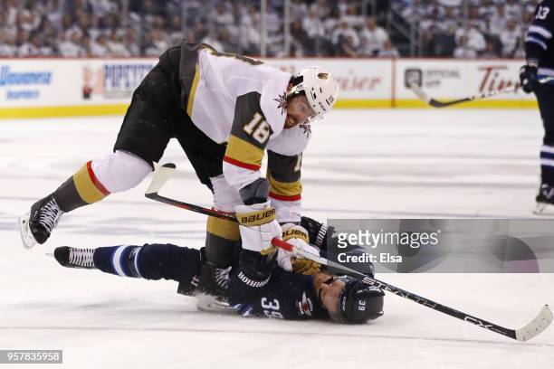 Toby Enstrom of the Winnipeg Jets is knocked down to the ice by James Neal of the Vegas Golden Knights during the second period in Game One of the...