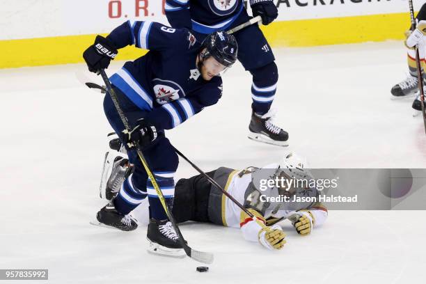 Andrew Copp of the Winnipeg Jets skates by Pierre-Edouard Bellemare of the Vegas Golden Knights during the second period in Game One of the Western...