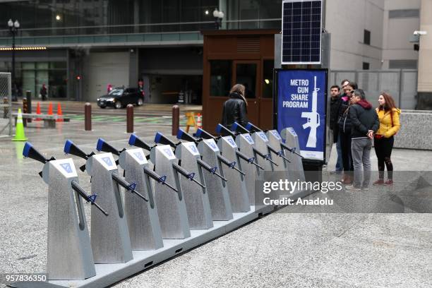 Row of 10 replicas of AR-15 rifles are displayed within the Gun Share Program to draw attention to armament at Daley Plaza in Chicago, United States...