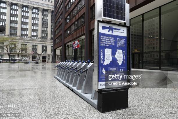 Row of 10 replicas of AR-15 rifles are displayed within the Gun Share Program to draw attention to armament at Daley Plaza in Chicago, United States...