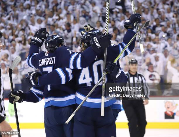 Ben Chiarot and Joel Armia of the Winnipeg Jets celebrate a first period goal against the Vegas Golden Knights with teammates on the ice in Game One...