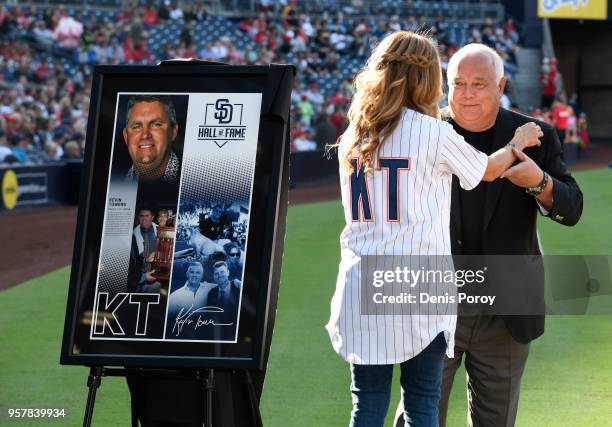 Kelley Towers, wife of former San Diego Padres general manager Kevin Towers, hugs Ron Fowler, Executive Chairman of the San Diego Padres, during a...